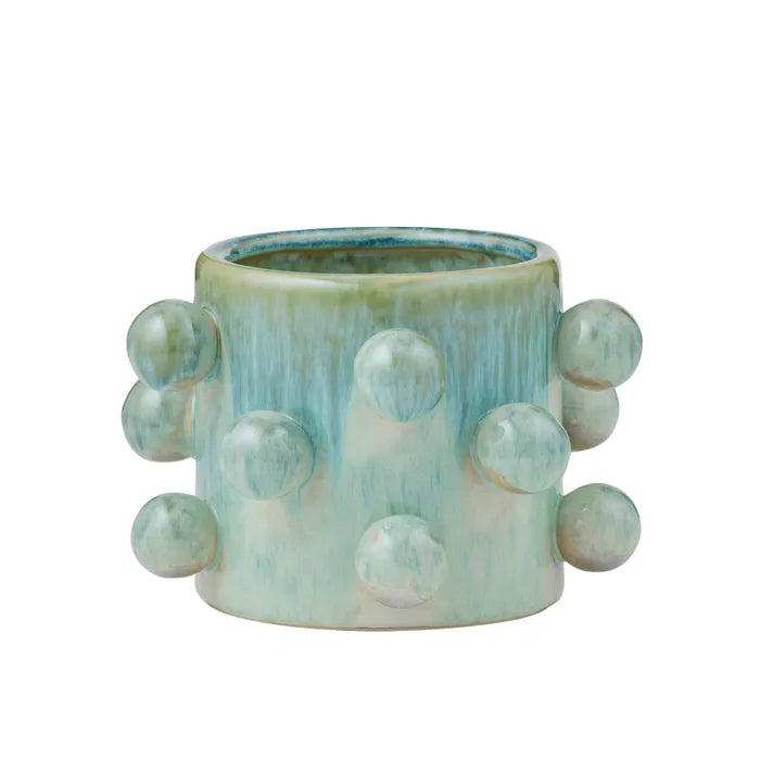 Ceramic planter with bubble-like protrusions on a white background