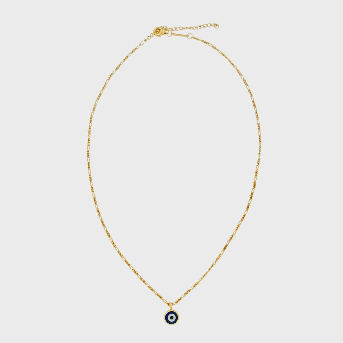 Gold necklace with a small evil eye pendant on a light gray background